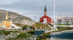 Greenland capital Nuuk with colored houses located near fjords and icebergs.