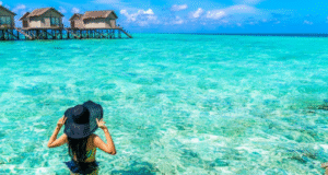 With tourists swimming in beautiful clear sea water of