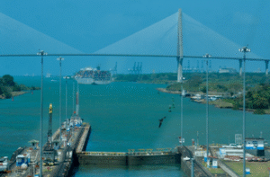 The container ship I saw earlier exits the third lane and is about to pass under the Atlantic Bridge